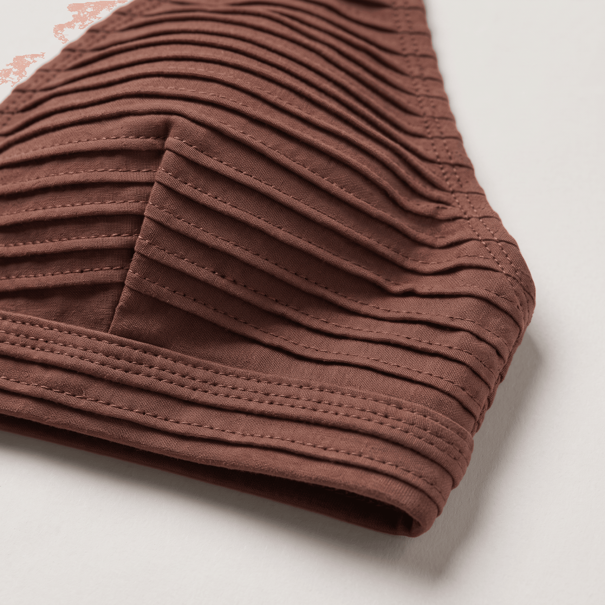 Macro crop of the fabric's cut edge, showing the density of the pile against a flat ground